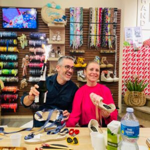 Participants holding their handmade espadrilles at the Barcelona craft workshop