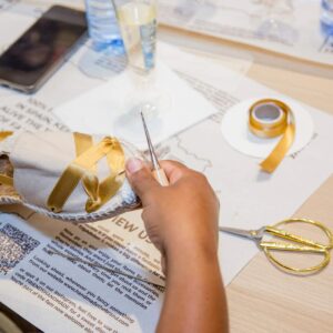 Close-up of hands crafting a pair of espadrilles during the Barcelona workshop