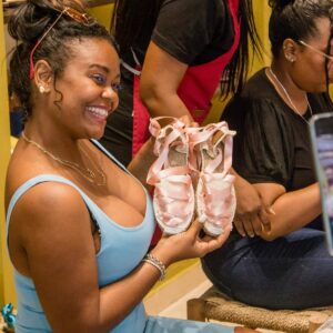 Traveler smiling with her handmade espadrilles at the Barcelona workshop